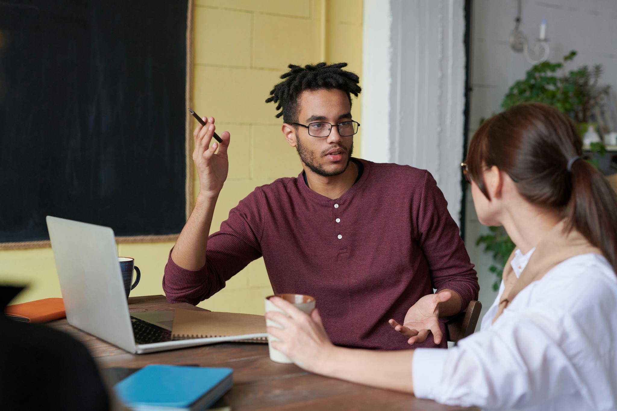 Two Colleagues Engaged In A Collaborative Discussion