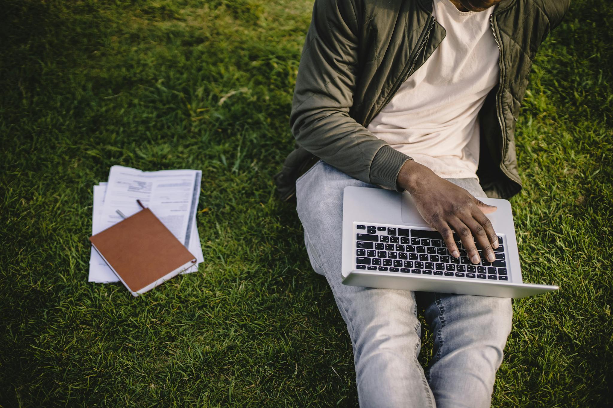 Young Adult Studying On A Laptop Outdoors